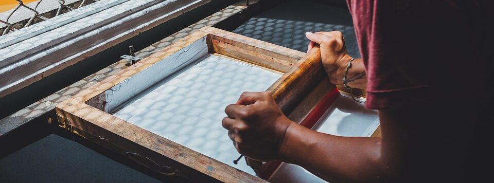 man doing screen printing