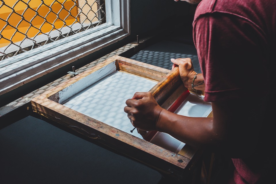 man doing screen printing